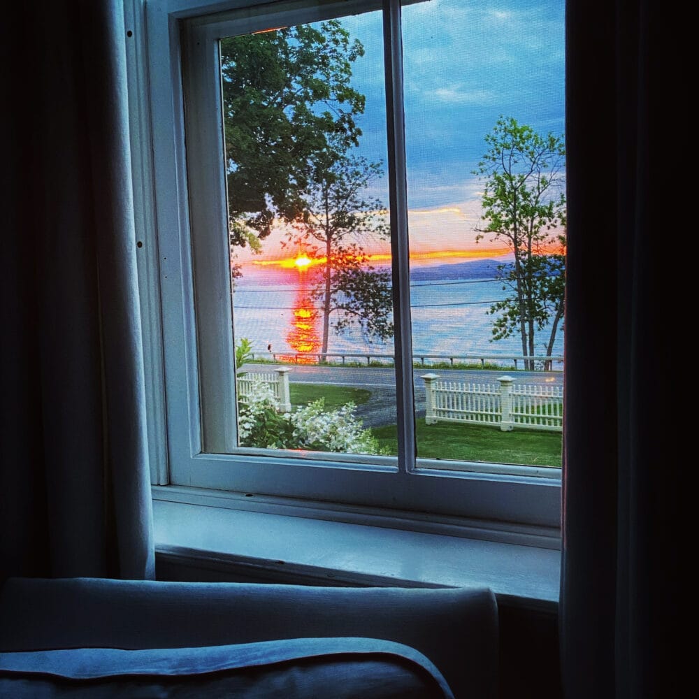 Daybreak: Lake Champlain sunrise through wavy-glass parlor window (Source: Geo Davis)