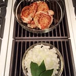 Organic chicken thighs, chopped onions and bay leaves.