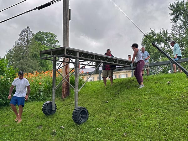 Tony, Tomasi, Supi, and Calvin Lowering a Dock Section (Photo: Geo Davis)