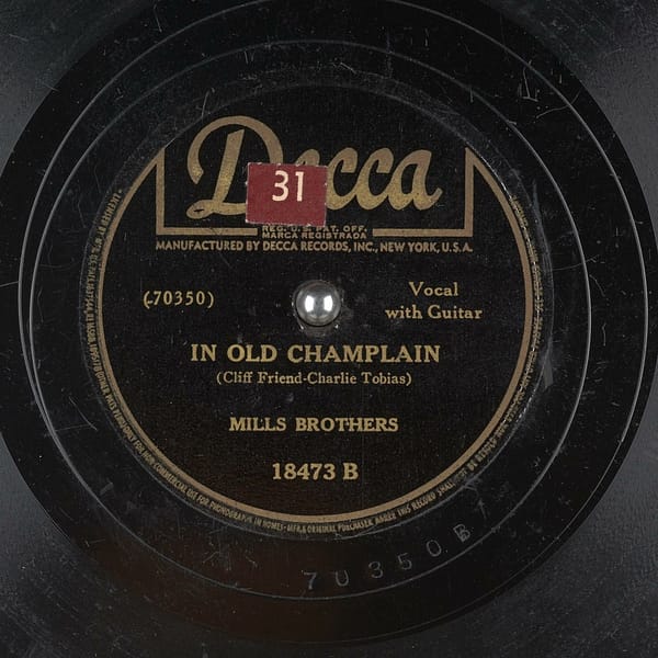 "In Old Champlain", released in 1942 by Decca Records, performed by Mills Brothers, and music/lyrics by Cliff Friend and Charlie Tobias
